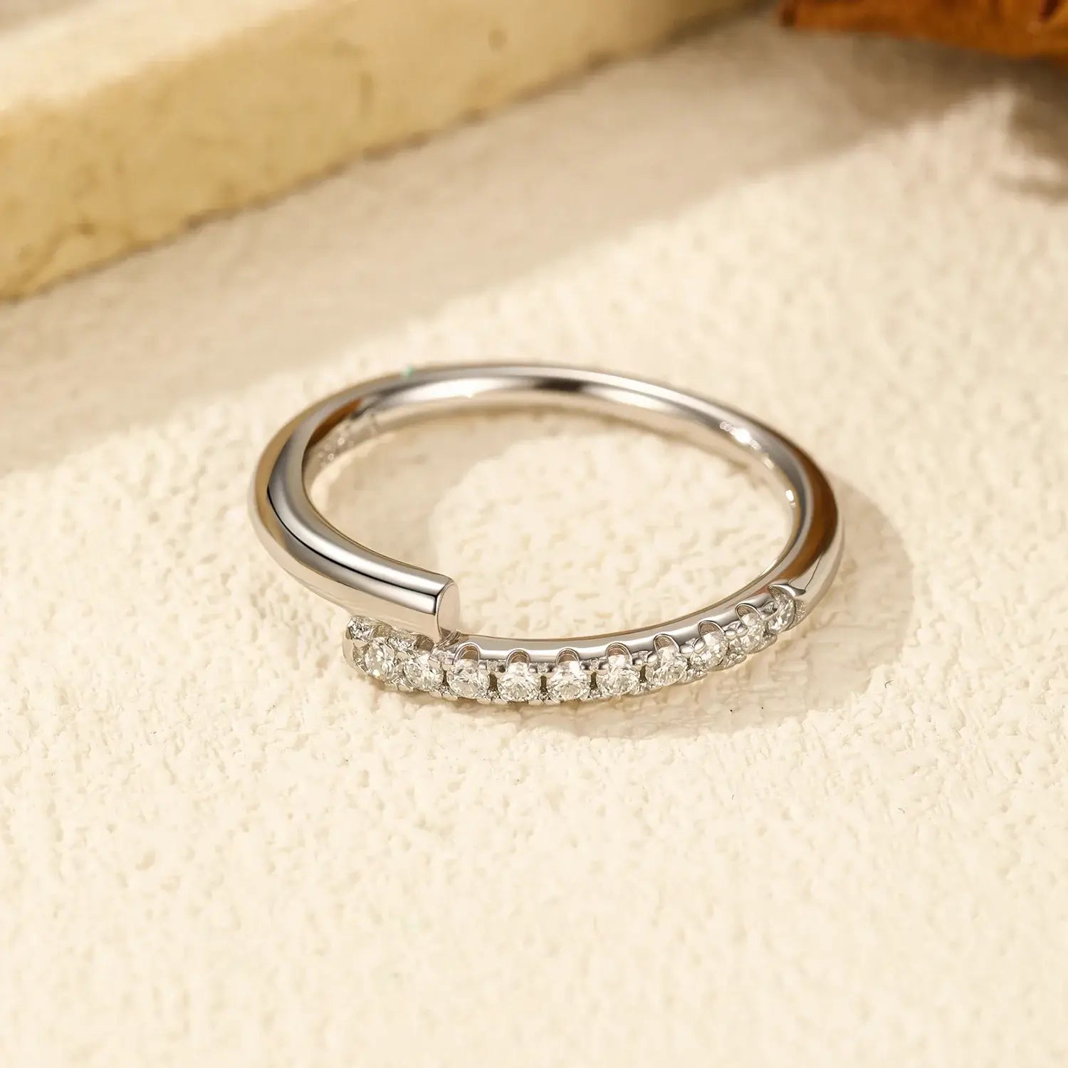 Round Pavé Moissanite Ring showcasing multiple D-color VVS1 stones in a sleek pavé setting.