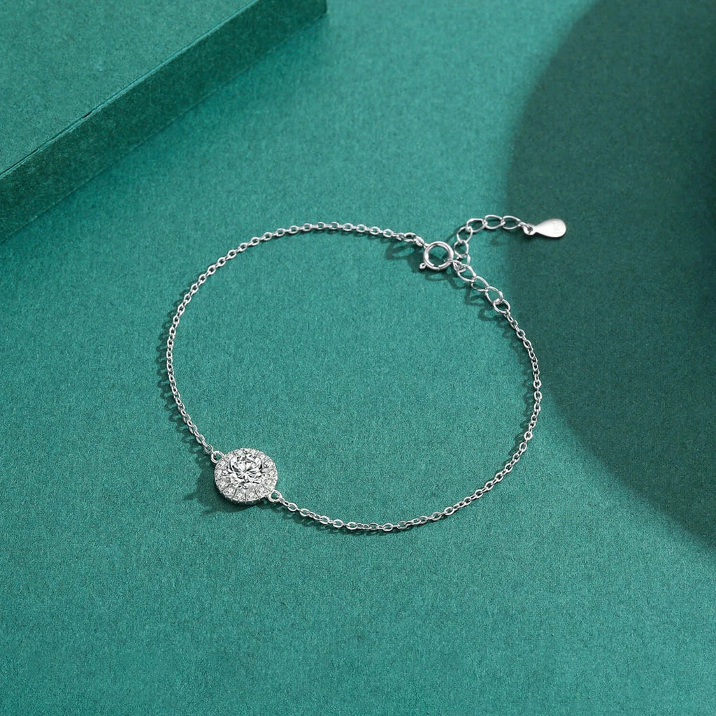 Round Zircon Charm Bracelet 925 Sterling Silver on a teal background, showcasing a sparkling zircon charm and adjustable chain.