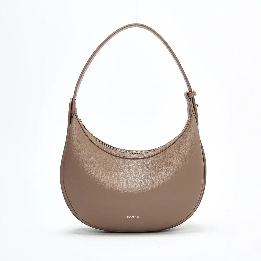 Half Moon Bag with Minimalist Design in soft brown color, featuring a zipper closure and single shoulder strap.