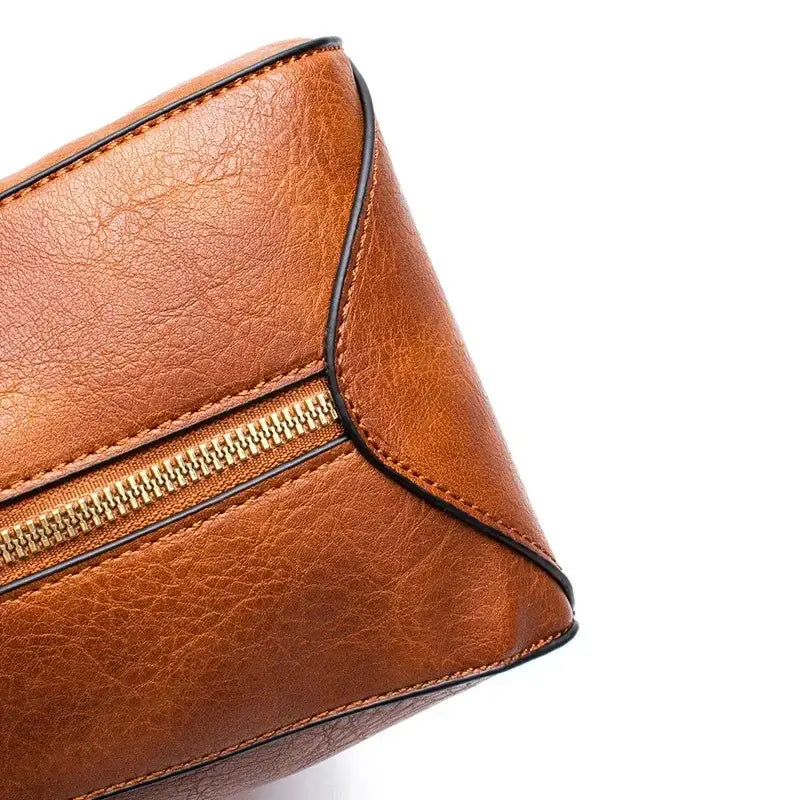 Hobo shoulder bag wallet pouch close-up detail of zipper and high-quality tan PU leather.