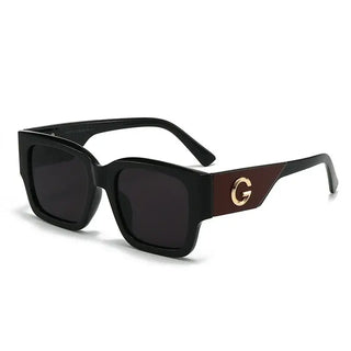 Sunglasses featuring a trendy gold G emblem on stylish black frames, perfect for casual wear.