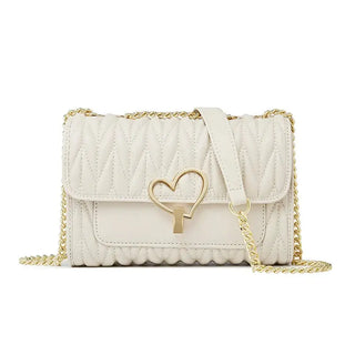 White quilted handbag with gold chain and heart-shaped clasp on a white background, featuring the FOXER brand.