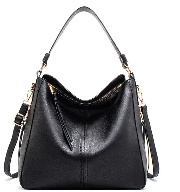 Hobo shoulder bag in black PU leather with slouchy silhouette and gold-tone hardware.
