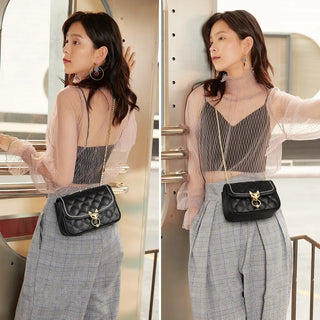 Stylish woman showcasing a leather crossbody bag with a zipper closure and sequined detail in a chic outfit.