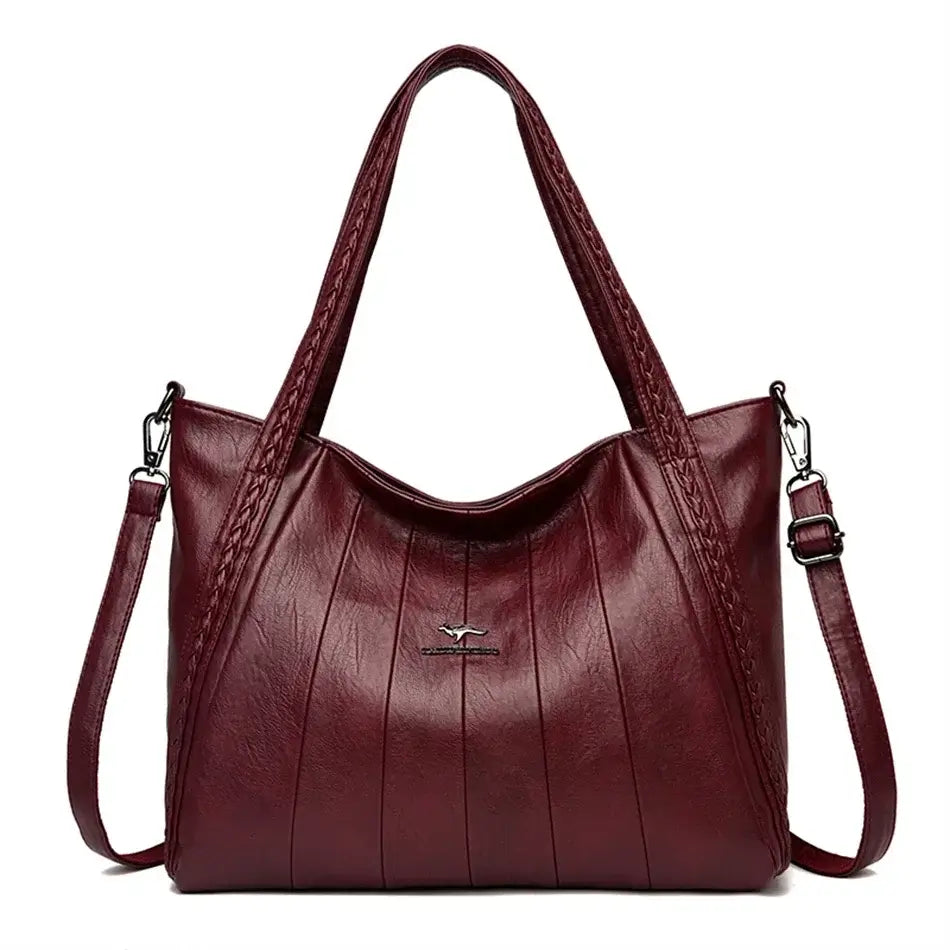 Soft Leather Handbag with zipper closure and kangaroo logo in burgundy color.