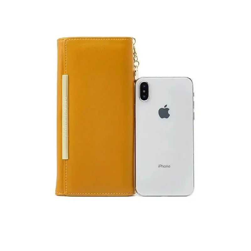 Wallet Leather for Women next to an iPhone, featuring a zipper closure and chain decoration.