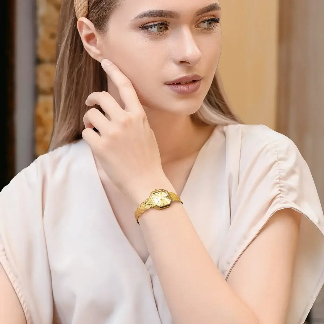 Elegant woman showcasing a stunning wristwatch stainless steel on her wrist, exuding sophistication and style.