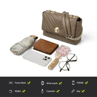 Shoulder Bag with Gold Chain next to various accessories like wallet, phone, and cosmetic items.