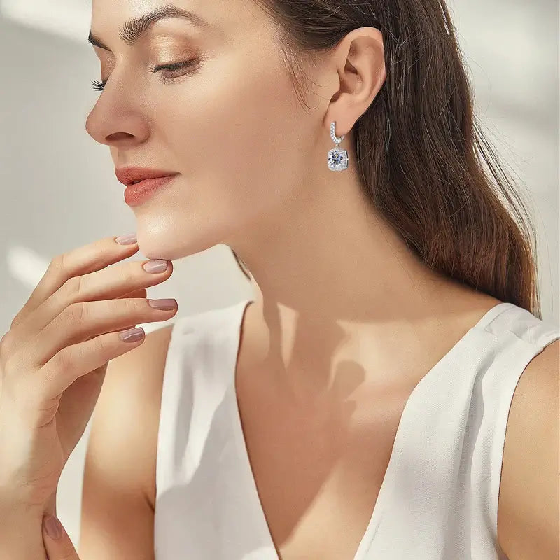 Woman wearing Moissanite Drop Earrings 925 Silver, showcasing elegant design and sparkling gemstones.