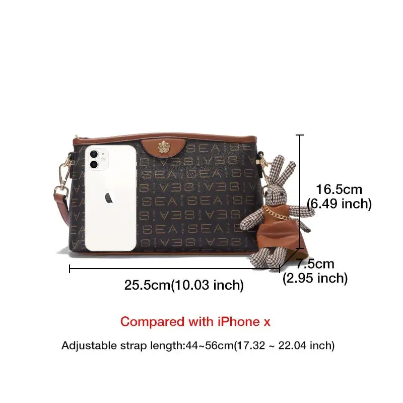 Monogram Crossbody Bag with Cute Bunny Charm displayed alongside an iPhone, highlighting size and adjustable strap.