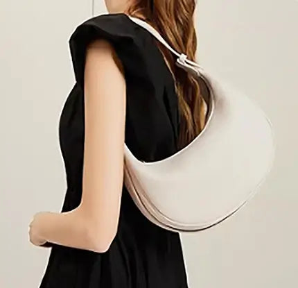 Half Moon Bag worn as a shoulder bag by a woman with a stylish outfit.
