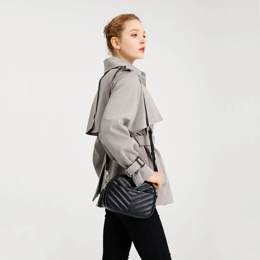 Model showcasing a stylish PU Crossbody Bag while wearing a fashionable trench coat