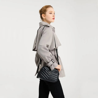 Model showcasing a stylish PU Crossbody Bag while wearing a fashionable trench coat