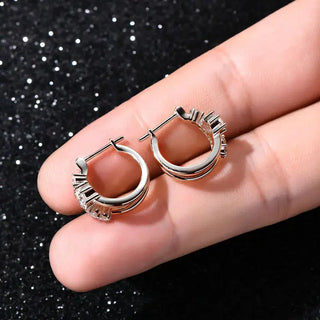 Moissanite Diamond Round Earrings for Women displayed in hand against sparkly background