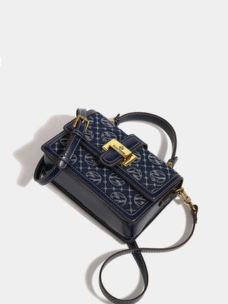 Crossbody Bag with Gold Detail in navy with floral pattern and shoulder strap.
