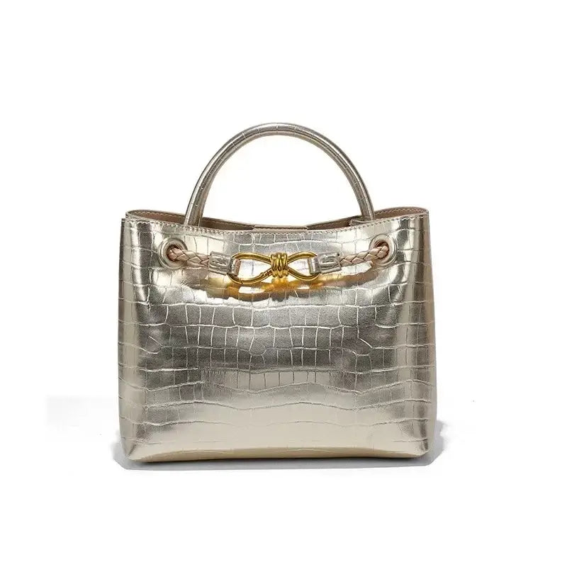 Women's Handbag Stone Pattern Tote Bag featuring a shiny metallic finish and stylish bow detail.