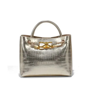 Women's Handbag Stone Pattern Tote Bag featuring a shiny metallic finish and stylish bow detail.