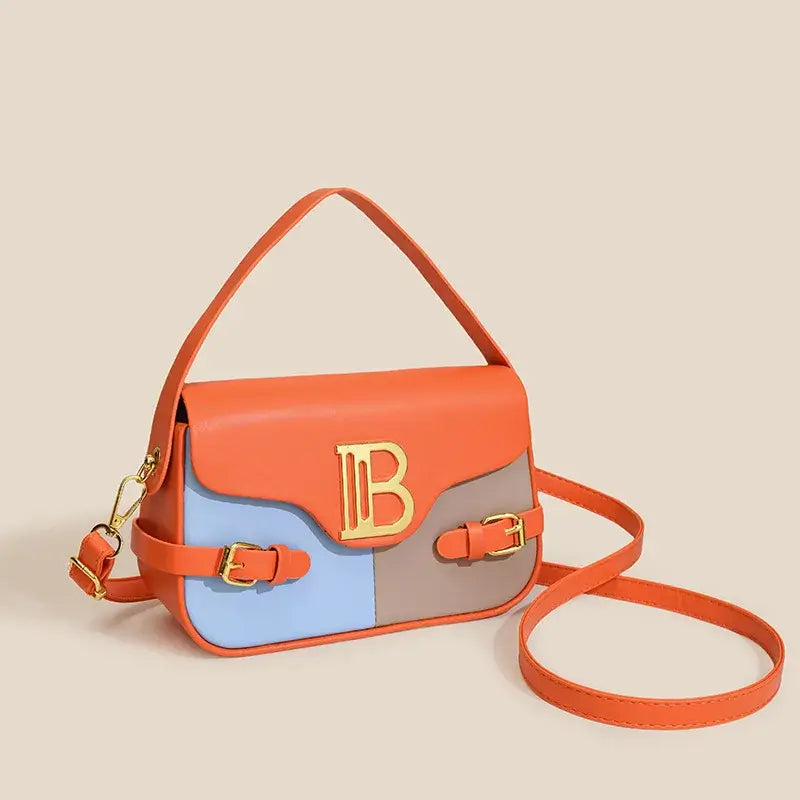 Womens crossbody bag with color-blocking design and stitching, featuring a stylish gold logo and an adjustable strap.