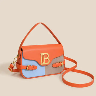 Womens crossbody bag with color-blocking design and stitching, featuring a stylish gold logo and an adjustable strap.