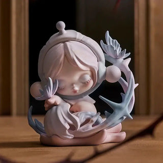 POP MART collectible figure in pastel colors, showcasing a dreamy character surrounded by foliage, perfect for display.