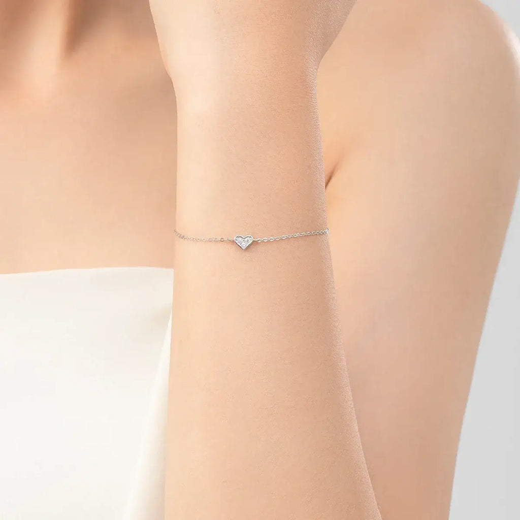 Bracelet 925 sterling silver with heart-shaped zircon accent worn on a woman's wrist.