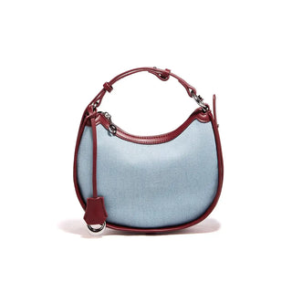 Denim Shoulder Bag with a soft blue exterior and burgundy leather accents, featuring a zipper closure and single strap.