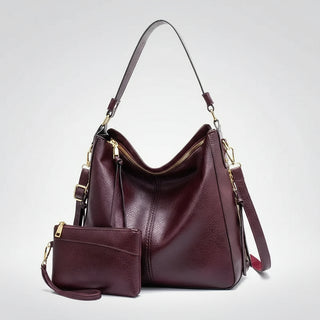 Hobo shoulder bag with matching wallet pouch in burgundy PU leather, featuring a slouchy silhouette and gold-tone hardware.