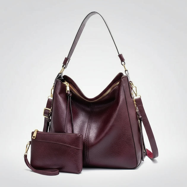 Hobo shoulder bag with matching wallet pouch in burgundy PU leather, featuring a slouchy silhouette and gold-tone hardware.