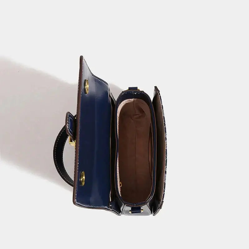 Inside view of navy blue Shoulder Crossbody Bag with gold details, showing spacious interior and flap pocket design.