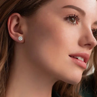Model showcasing Round Moissanite Stud Earrings in a close-up photo.