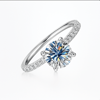 Moissanite Ring 925 Sterling Silver featuring a round-cut Moissanite stone with sparkling zircon accents.