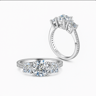 Moissanite Ring – 925 Sterling Silver Three-Stone Design featuring stunning round-cut moissanite center stone.
