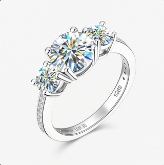 Moissanite Ring – 925 Sterling Silver Three-Stone Design featuring sparkling round-cut moissanite stones.