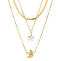 Two gold necklaces with star and moon pendants on a white background