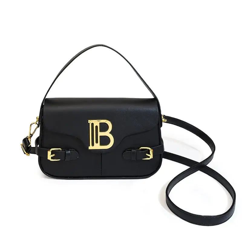 Womens crossbody bag with color-blocking and stitching, featuring a stylish black design and gold accents.