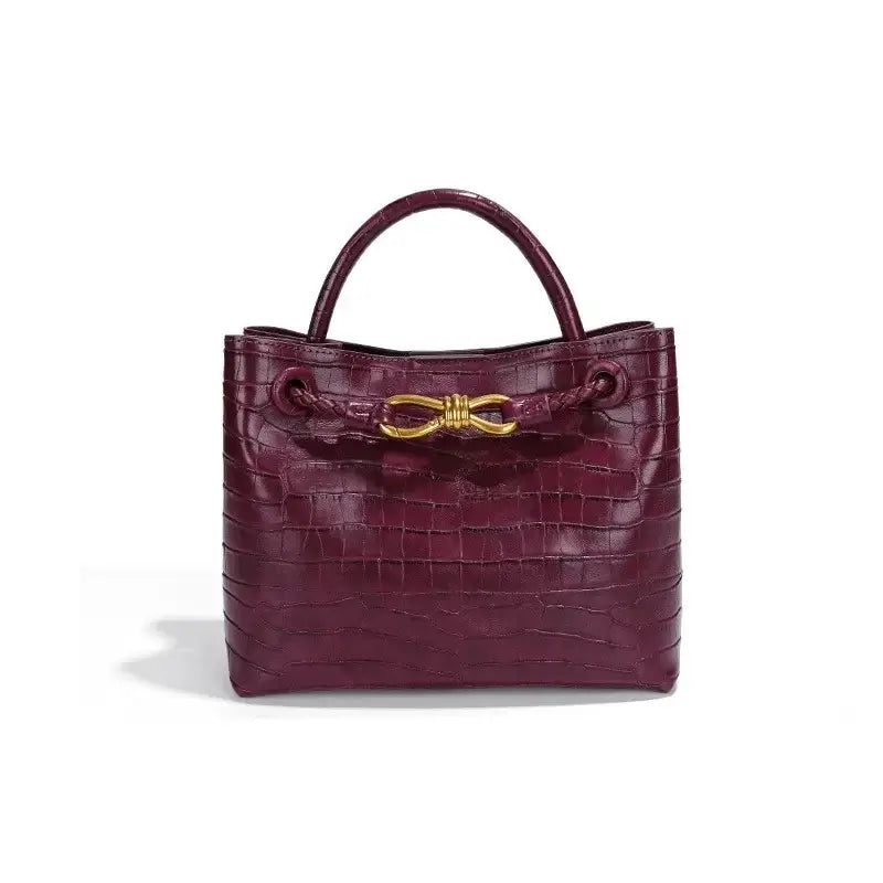 Women's Handbag in burgundy crocodile pattern with gold closure, perfect for styling and everyday use.
