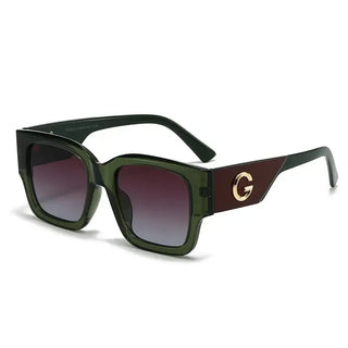 Sunglasses with gold G emblem featuring green frame and gradient lenses, perfect for casual wear.