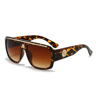 Sunglasses with gold detailing in a stylish tortoiseshell design, perfect for casual adult wear.