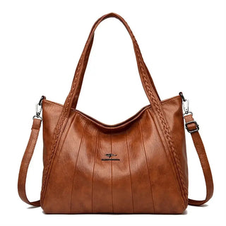 Soft Leather Handbag featuring a zipper closure, kangaroo logo, and stylish braided straps.