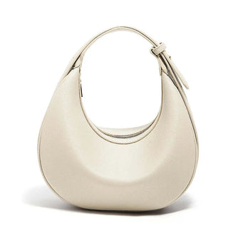 Half Moon Bag with Minimalist Design in soft beige color, featuring a single handle and zipper closure.