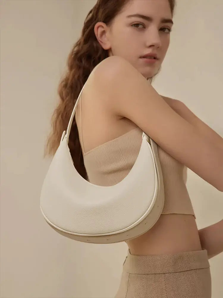Half Moon Bag with Minimalist Design worn casually by a model, showcasing its soft white PU material.