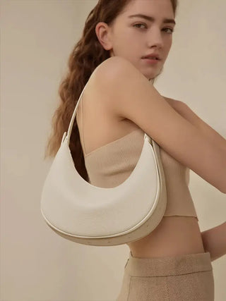 Half Moon Bag with Minimalist Design worn casually by a model, showcasing its soft white PU material.