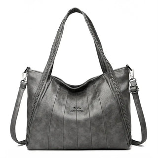 Soft Leather Handbag featuring a zipper closure with kangaroo logo and silt pocket for women.