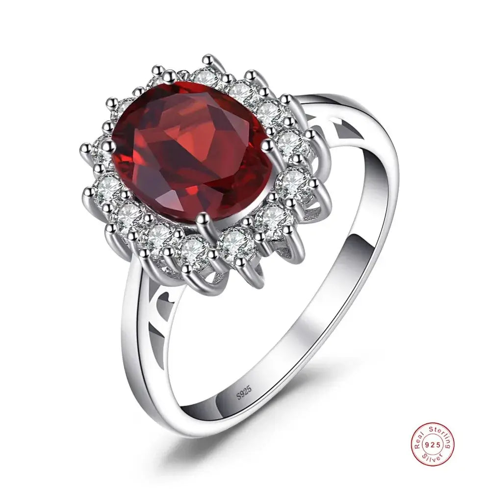 Rings featuring a stunning oval red gemstone surrounded by sparkling crystals, crafted in sterling silver.