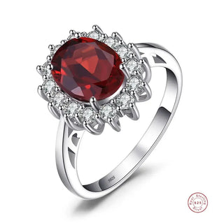 Rings featuring a stunning oval red gemstone surrounded by sparkling crystals, crafted in sterling silver.