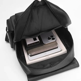 Interior view of a black leather Backpack for Men showing a large capacity for travel essentials and electronics.