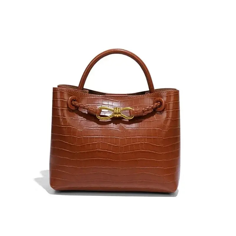 Women's Handbag in a stylish brown crocodile pattern with a decorative gold closure.