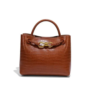 Women's Handbag in a stylish brown crocodile pattern with a decorative gold closure.