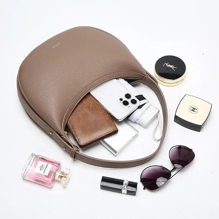 Half Moon Bag with Minimalist Design open showing interior contents including wallet and phone.