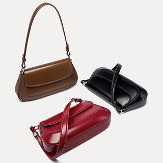 Shoulder bag leather in brown, black, and red hues, featuring a structured design with minimalist appeal and stylish function.
